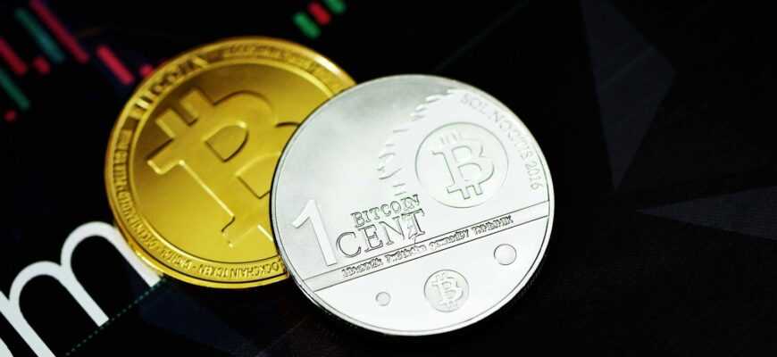 gold round coin on black surface