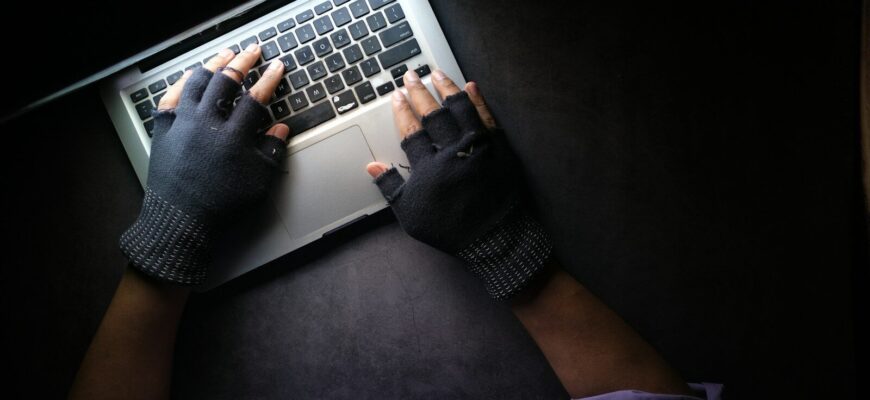 person in black long sleeve shirt using macbook pro