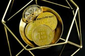 a golden bitcoin sitting on top of a gold plate