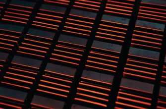 a close up of a metal grate with red lights