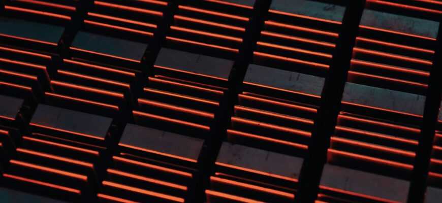 a close up of a metal grate with red lights